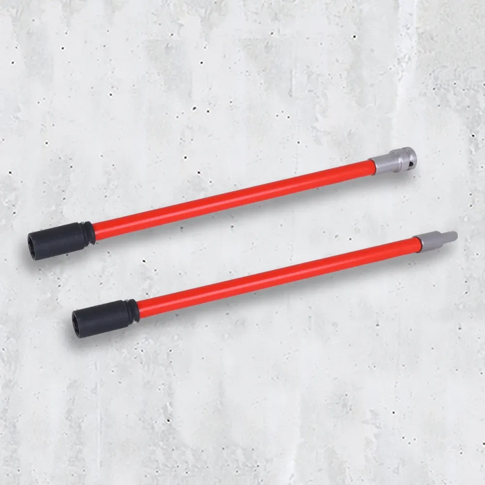 Dos herramientas de montaje rojas con extremos negros y plateados sobre una superficie de hormigón gris claro.
